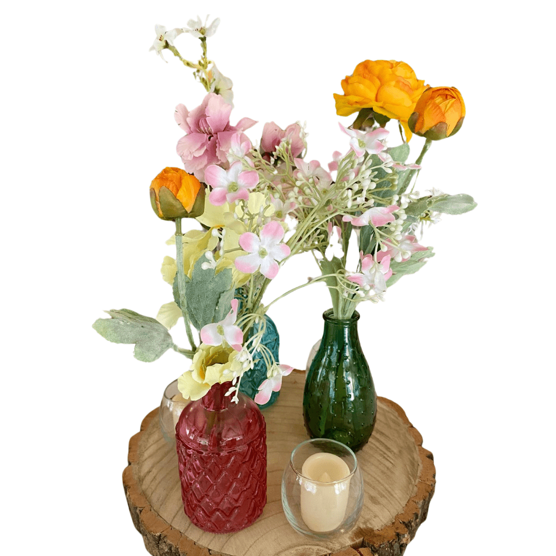 Vintage Coloured Bottles With Artificial Flower and Log Slice